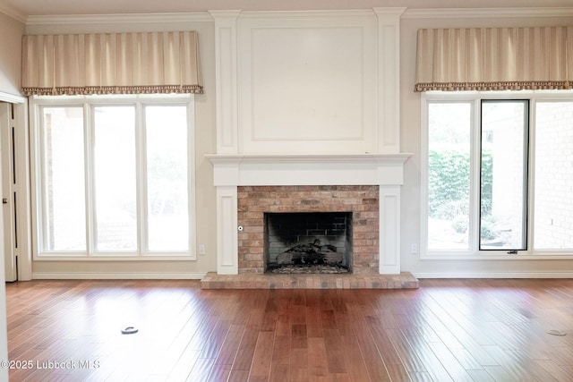 4420 87th St, Lubbock, TX 79424 - unfurnished living room with crown molding, wood finished floors, and a fireplace