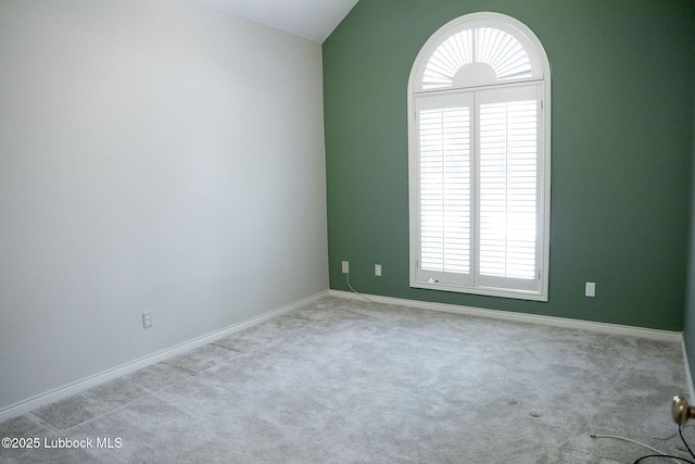 4420 87th St, Lubbock, TX 79424 - carpeted empty room with vaulted ceiling and baseboards