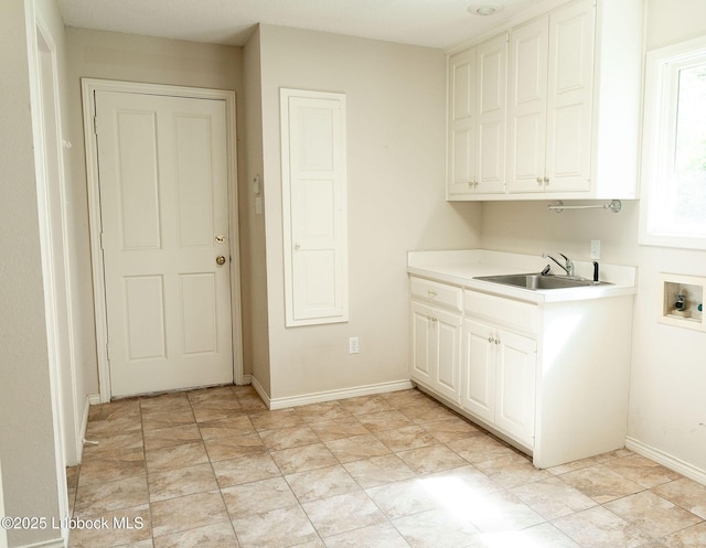 4420 87th St, Lubbock, TX 79424 - clothes washing area featuring washer hookup, cabinet space, and baseboards