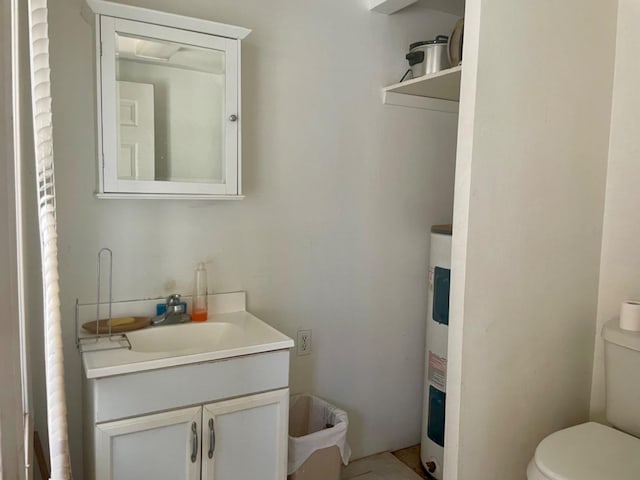 bathroom with vanity, toilet, and water heater