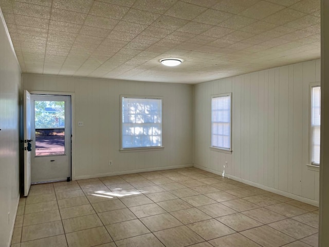 tiled empty room with a healthy amount of sunlight