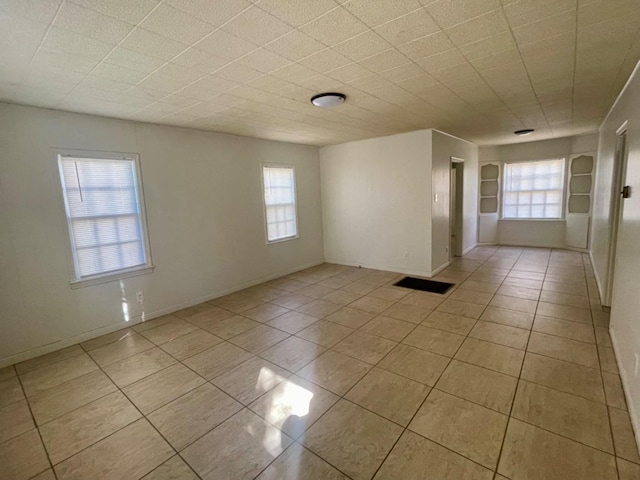 tiled empty room with built in shelves