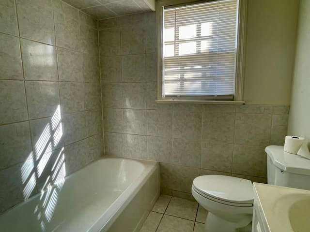 bathroom featuring a tub to relax in, toilet, tile walls, vanity, and tile patterned flooring