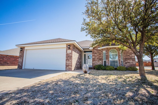 3602 Pontiac Ave, Lubbock, TX 79407 - ranch-style house featuring an attached garage, driveway, and brick siding