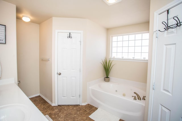 3602 Pontiac Ave, Lubbock, TX 79407 - bathroom with a bath, baseboards, and a sink
