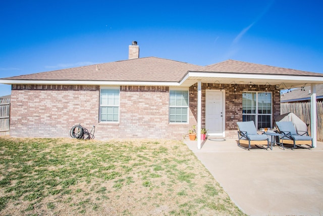 3602 Pontiac Ave, Lubbock, TX 79407 - rear view of house with a chimney, fence, a patio, and brick siding