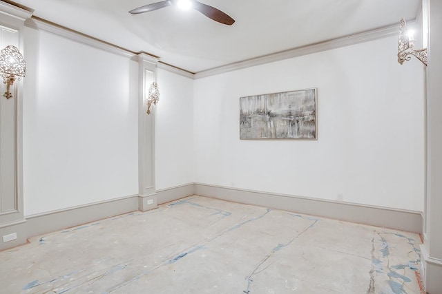 empty room featuring decorative columns, ornamental molding, and ceiling fan