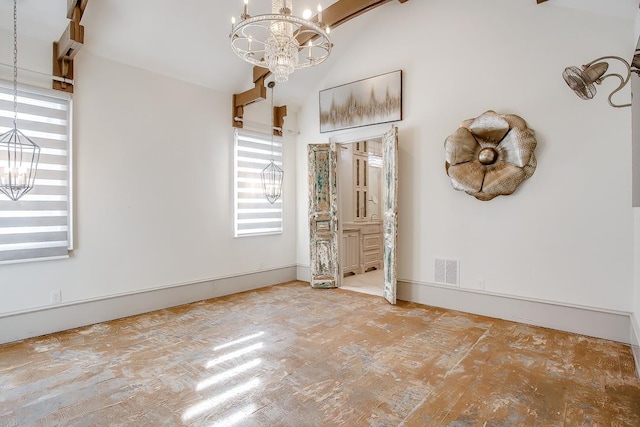 spare room featuring vaulted ceiling and a notable chandelier