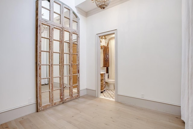 interior space featuring ornamental molding and light wood-type flooring