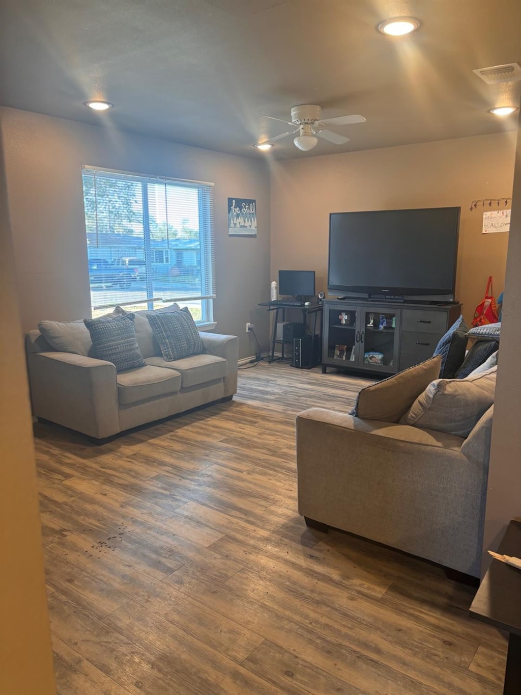 living room featuring dark hardwood / wood-style flooring and ceiling fan