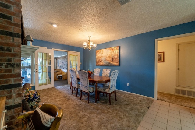 dining area featuring carpet flooring, a notable chandelier, and a textured ceiling