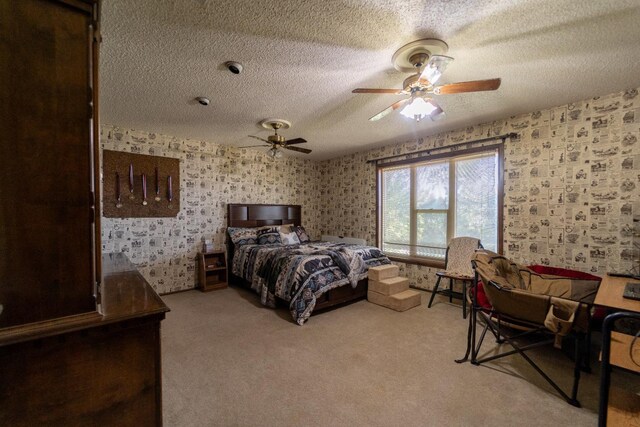 bedroom with light carpet, ceiling fan, and a textured ceiling