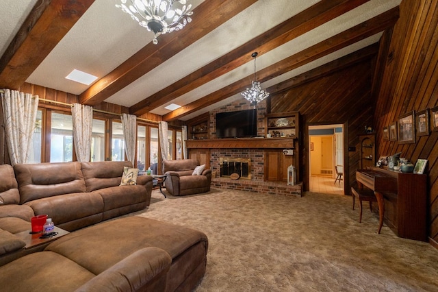 carpeted living room featuring lofted ceiling with beams, a brick fireplace, an inviting chandelier, and wooden walls