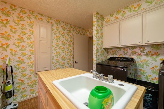 bathroom with sink, parquet floors, and a textured ceiling