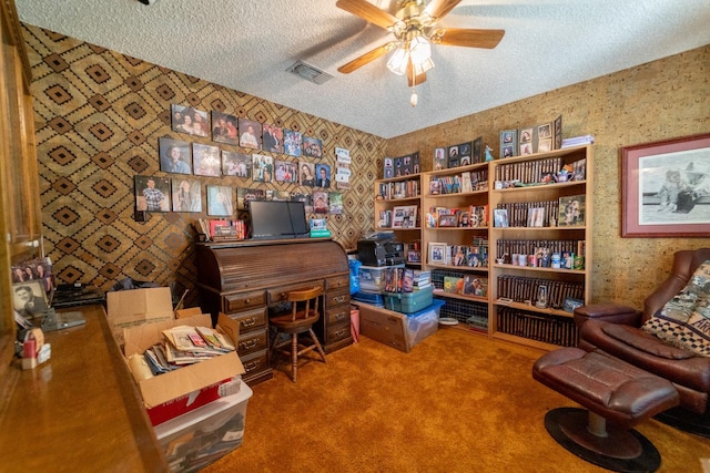 home office with ceiling fan, carpet floors, and a textured ceiling