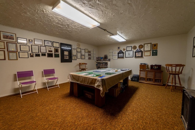 recreation room featuring dark carpet, billiards, and a textured ceiling