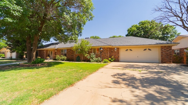 single story home featuring a garage and a front lawn