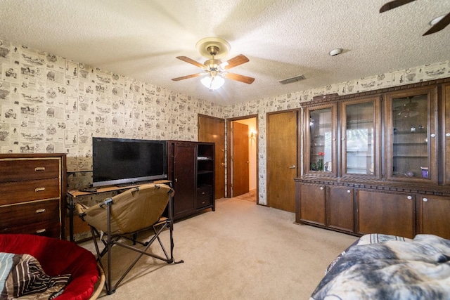 carpeted office with ceiling fan and a textured ceiling