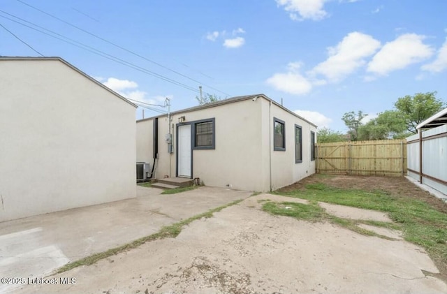 1502 30th St, Lubbock, TX 79411 - rear view of property with a fenced backyard, stucco siding, and a patio area