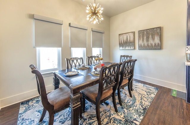 dining space featuring dark wood-type flooring and a chandelier