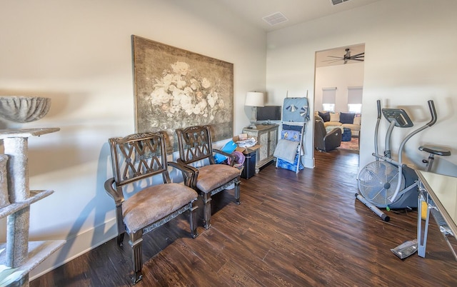 sitting room featuring ceiling fan and dark wood-type flooring