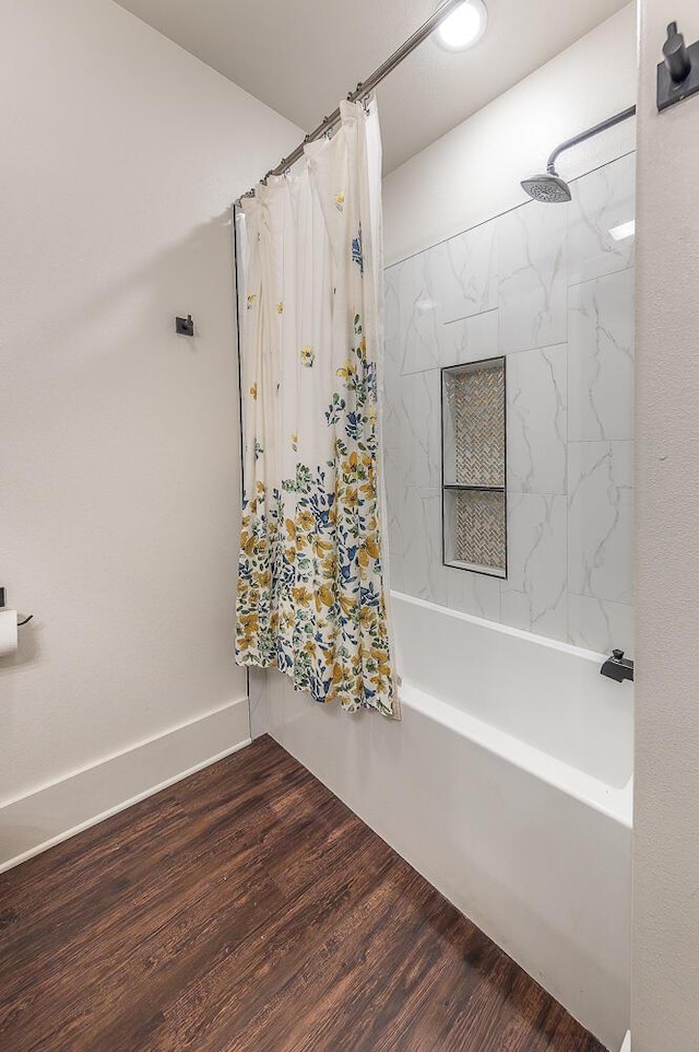 bathroom with hardwood / wood-style floors and shower / bathtub combination with curtain