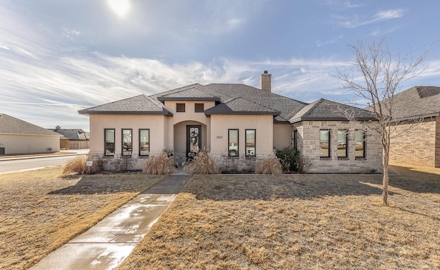 prairie-style house featuring a front lawn