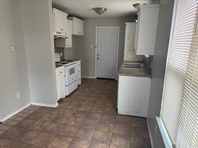 kitchen featuring white cabinetry, white electric range, and sink