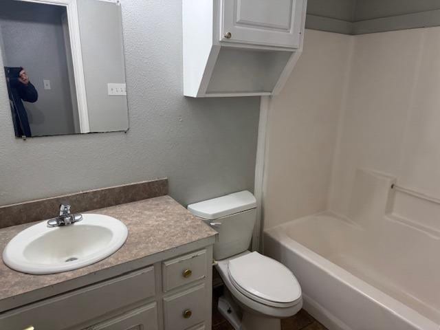 full bathroom featuring vanity, toilet, and washtub / shower combination