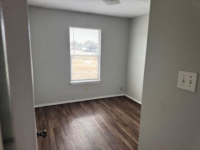 spare room featuring dark wood-type flooring