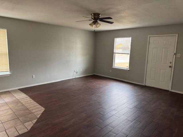 spare room featuring dark hardwood / wood-style floors and ceiling fan