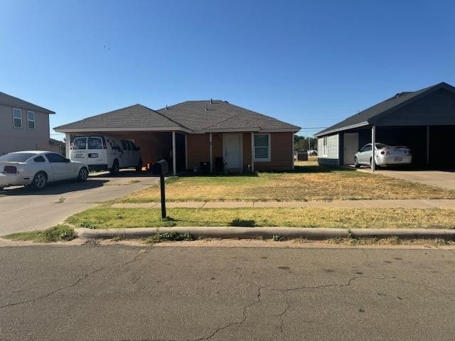 ranch-style house featuring a front yard and a carport