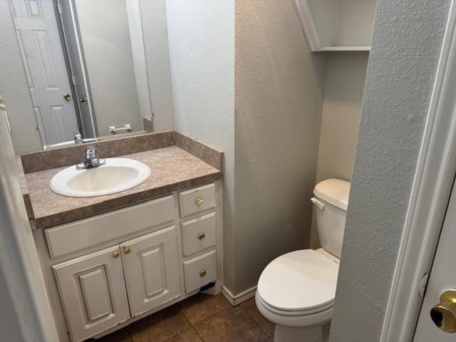 bathroom with vanity, toilet, and tile patterned flooring