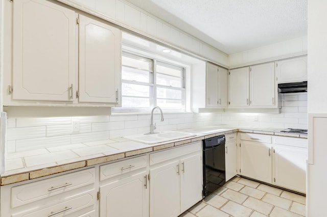 kitchen with white cabinetry, tile countertops, black dishwasher, and sink