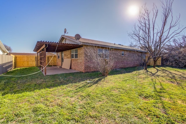 rear view of house with a patio area and a lawn