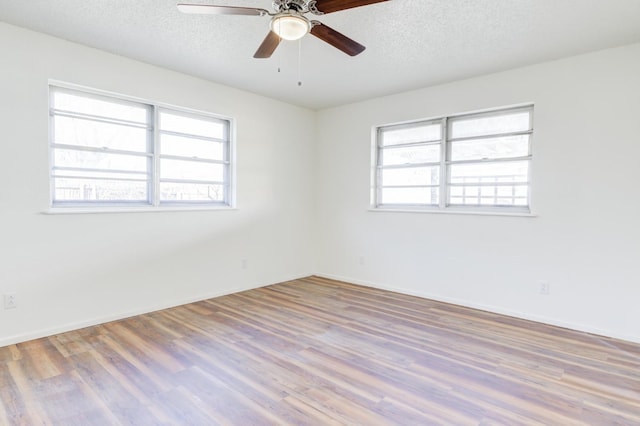 unfurnished room with ceiling fan, a textured ceiling, and light hardwood / wood-style flooring