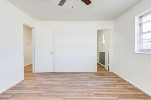 unfurnished bedroom featuring light hardwood / wood-style flooring and ceiling fan