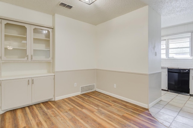 interior space featuring light hardwood / wood-style floors and a textured ceiling