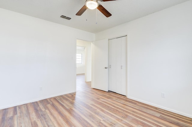 empty room with ceiling fan and light wood-type flooring