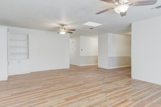 empty room featuring light hardwood / wood-style floors and a textured ceiling