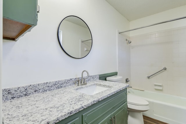 full bathroom with tiled shower / bath, vanity, toilet, and wood-type flooring