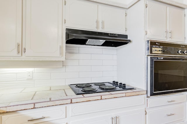 kitchen featuring white cabinets, black electric stovetop, and oven