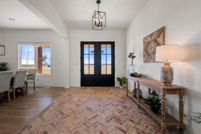 entryway with a chandelier and french doors