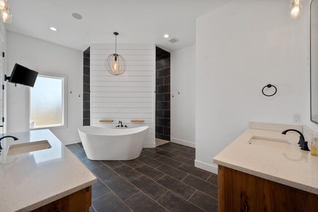 bathroom featuring a washtub and vanity