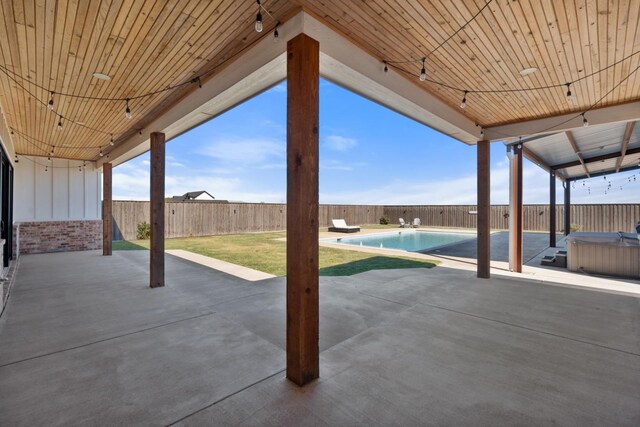 view of patio with a pool with hot tub