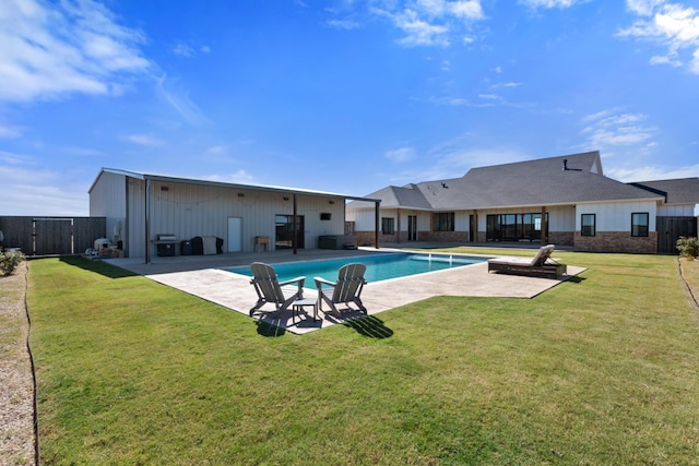 view of swimming pool with a yard and a patio area