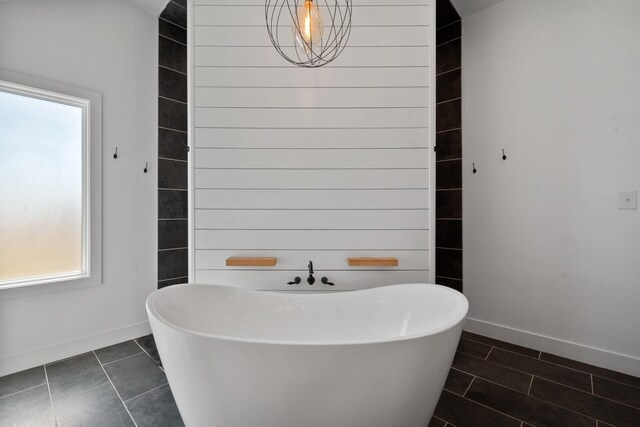 bathroom featuring tile patterned flooring and a bathtub