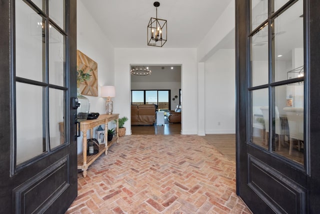 entrance foyer featuring a notable chandelier