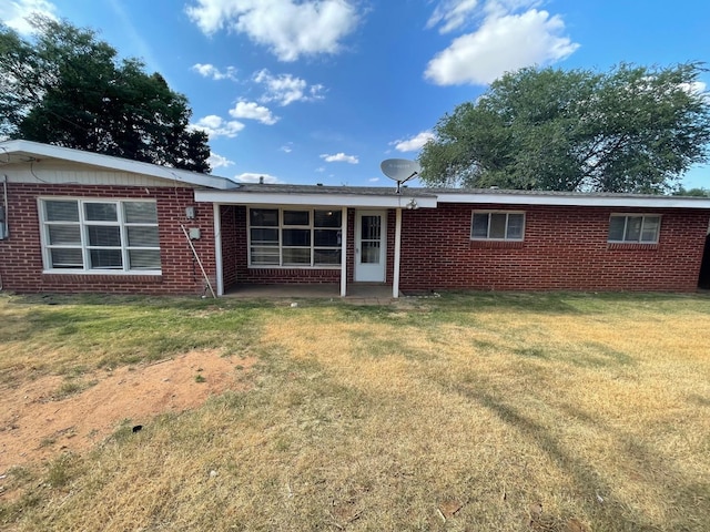 back of house with a lawn