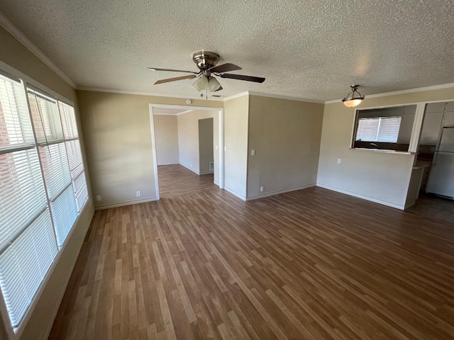 interior space with crown molding, ceiling fan, a textured ceiling, and dark hardwood / wood-style flooring